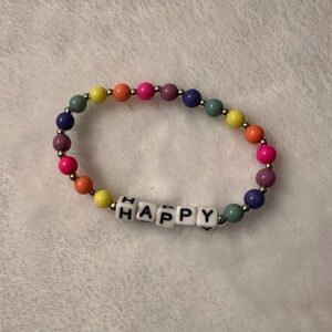 Happy charm stretchy bracelet. Rainbow color beads.